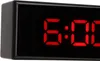 A close-up of a digital alarm clock displaying the time. Voir les images du produit