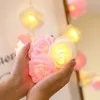 Hands holding a string of LED rose lights. Produktbild-Vorschau