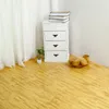A corner of a room with a white cabinet, a plant, books, a teddy bear, and a wooden floor. Produktbild-Vorschau