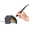 A hand holding a soldering iron over a black soldering tip cleaner. Produktbild-Vorschau