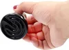 A hand holding a black ceramic heat lamp bulb. Podgląd zdjęcia produktu
