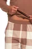 A close-up shot of a person's torso wearing a brown long-sleeved shirt and plaid pajama bottoms. Produktbild-Vorschau