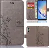 A collage of images showing a grey flip phone case with a floral pattern, a phone inside the case, and the back of the case. Produktbild-Vorschau