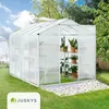A Juskys aluminum greenhouse with plants inside, set up in a backyard garden. Produktbild-Vorschau