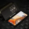 A black leather wallet case for a smartphone is open, showing three cards inserted and a glimpse of a smartphone screen with a colorful abstract image. Produktbild-Vorschau