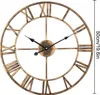 A large, round, vintage-style wall clock with Roman numerals and black hands. Produktbild-Vorschau