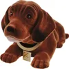 A brown plush dog figurine with a collar and tag, lying down. Produktbild-Vorschau