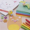 A collection of craft supplies for children, including paper, markers, stickers, and clay figures. Produktbild-Vorschau