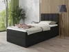A bedroom scene with a bed, plant, and lamp.