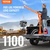 A man is operating a truck-mounted crane to lift an engine into the bed of a pickup truck. Construction equipment is visible in the background. Anteprima dell’immagine prodotto