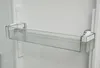 A close-up view of a clear plastic shelf attached to the interior wall of a refrigerator. Produktbild-Vorschau