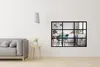 A modern living room with a grey sofa and a decorative window pane on the wall showing a kitchen. Produktbild-Vorschau