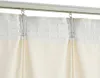 Close-up of cream-colored curtains hanging from a track with clips. Náhled obrázku produktu