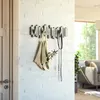 A wall-mounted coat rack with a bag and leash hanging from it, next to a door. The background is a white brick wall and a blurry glimpse of a living room. The image appears to be a product shot for an e-commerce website. Náhľad obrázku produktu