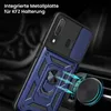 A close-up of a blue and black phone case with a ring holder, attached to a car air vent via a magnetic mount. Produktbild-Vorschau
