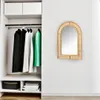 A mirror hanging on a wall next to a closet with clothes. Podgląd zdjęcia produktu