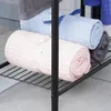 Rolled towels on a black metal shelf. Voir les images du produit