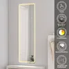 A full-length mirror with integrated LED lighting is displayed in a room, reflecting a door and a plant. Informational icons and text are overlaid on the right side of the image. Produktbild-Vorschau