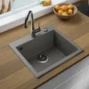 A kitchen sink with a faucet and a bowl of fruit on a wooden countertop. Produktbild-Vorschau