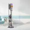 A cordless vacuum cleaner is displayed on a floor stand in a room. Voir les images du produit