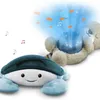 A plush crab and a plush bear are shown, with the bear projecting a blue light with fish and musical notes. Náhled obrázku produktu