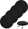 A group of four black round stool covers and one stool cover on a stool are arranged against a white background. Produktbild-Vorschau