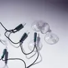 A close-up shot of several suction cups attached to a string of Christmas lights. Produktbild-Vorschau