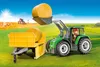 A toy tractor with a trailer and hay bales on a farm. Voir les images du produit
