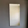 A rectangular mirror with a geometric pattern is mounted on a gray wall. Náhled obrázku produktu