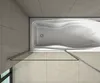 A top-down view of a bathtub with a glass shower enclosure. Produktbild-Vorschau