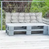 A gray cushion sits on a white pallet bench on a wooden deck, with greenery in the background. Náhľad obrázku produktu