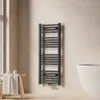 A modern bathroom setting with a towel radiator, a wooden stool with a towel, and a bathtub. Anteprima dell’immagine prodotto
