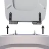 A toilet seat being detached from the toilet bowl using a quick-release mechanism. Anteprima dell’immagine prodotto