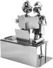 Two metal figures, resembling engineers or technicians, are looking at blueprints or plans at a desk with a laptop. Produktbild-Vorschau