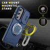 A blue phone case with a magnetic ring stand is shown attached to a car mount on a car dashboard. Náhled obrázku produktu