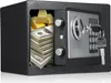 An open safe filled with stacks of money and gold bars. A key is in the lock. Produktbild-Vorschau