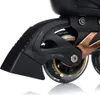 A close-up view of the wheel and frame of a black and gold inline skate. Náhled obrázku produktu
