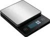 A digital kitchen scale with a brushed metal top and a black base is shown from a slightly elevated angle. Voir les images du produit