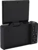 A black digital camera with its screen flipped up, shown from a rear-diagonal angle against a white background. Voir les images du produit