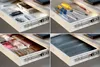 Four drawers of a desk are shown, each organized with different items: office supplies, tools, and small items in boxes. Náhľad obrázku produktu