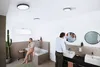 A couple in a modern bathroom, one person on the phone by the bathtub, the other grooming at the sink. Produktbild-Vorschau