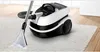 A Bosch Serie 4 vacuum cleaner is shown on a white carpet, with its cleaning attachment in use. Náhled obrázku produktu