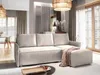 A modern living room with a cream-colored sectional sofa and an ottoman, styled with a throw blanket. The room features large windows, curtains, and a woven pendant light. Produktbild-Vorschau