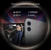 A woman is shown in the driver's seat of a car, with a smartphone displayed next to her, highlighting its camera features. Produktbild-Vorschau