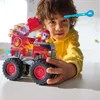 A child is playing with a toy fire truck. Produktbild-Vorschau