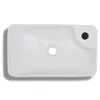 A top-down view of a white ceramic sink with a drain hole in the center and an overflow hole on the right. Náhled obrázku produktu