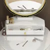 A close-up view of a vanity table with makeup and accessories. Podgląd zdjęcia produktu