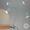 A light blue clip-on desk lamp with four adjustable gooseneck arms and LED lights, attached to a wooden surface. Produktbild-Vorschau