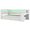 A white daybed with integrated shelving and a pull-out bed, featuring green LED lighting. Náhled obrázku produktu