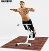 A man is performing a back extension exercise on a white fitness machine, which is placed on a wooden-patterned mat. The background is plain white. Náhľad obrázku produktu